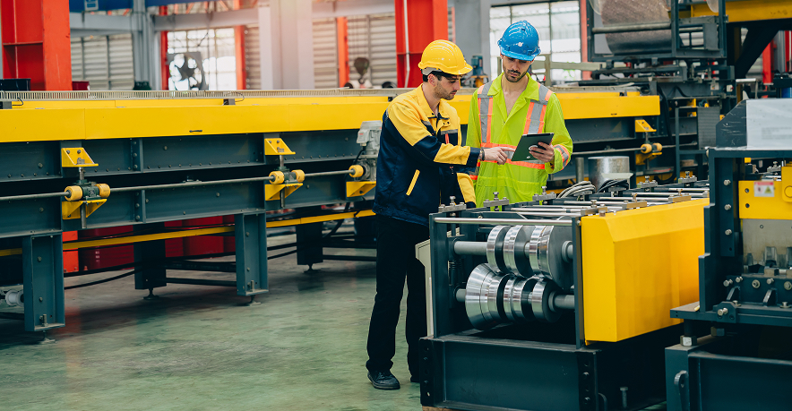 Engineers working in a manufacturing assembly area. Engineers working in a manufacturing assembly area.