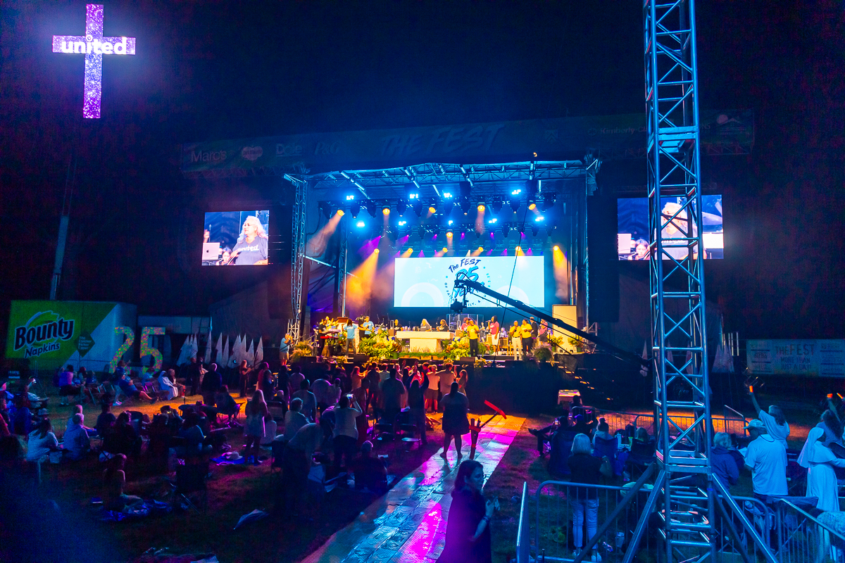 Stage setup by NPi Audio Visual Solutions showing lighting and video equipment protected with Checkers Safety cable protectors during a live event